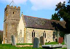 Stone building with square tower.